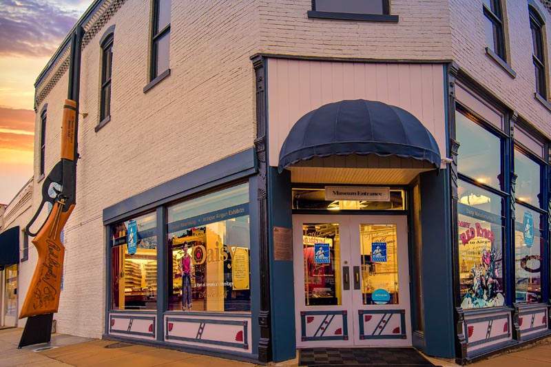 World's Largest Daisy BB Gun at the museum entrance at sunset